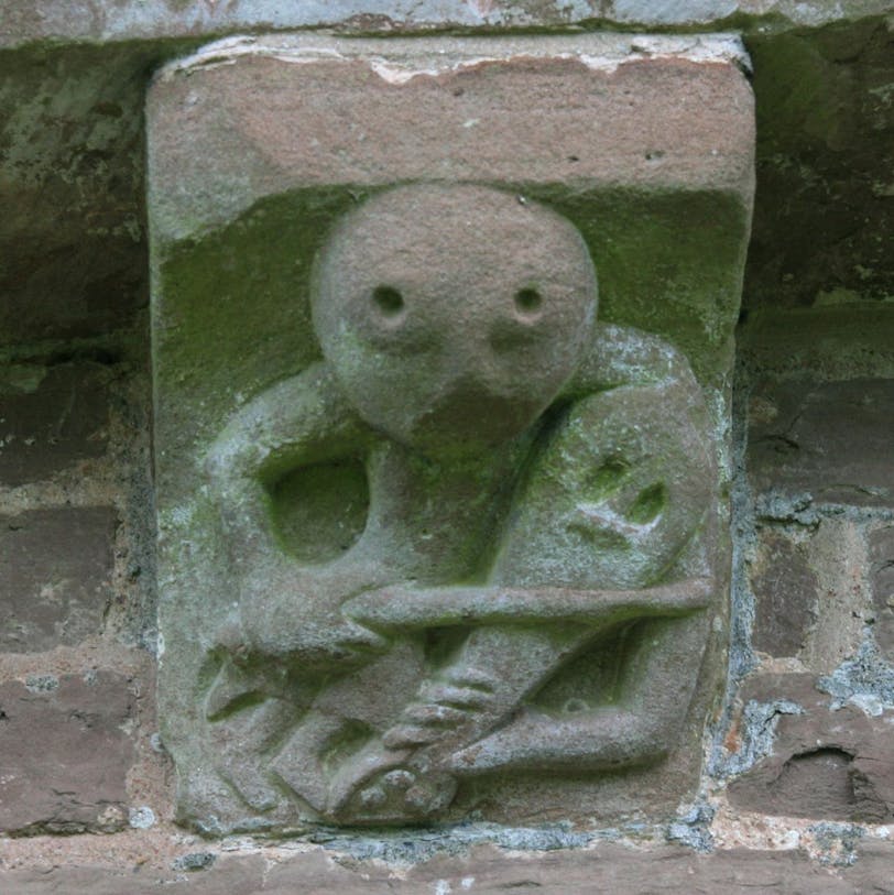 corbel 45: man playing rebec